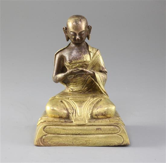 A Chinese gilt copper seated figure of a luohan, probably Qing dynasty, height 15cm